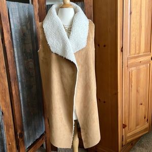 Faux suede, faux sheepskin vest. Camel colored, V shaped front edge. New w/tags
